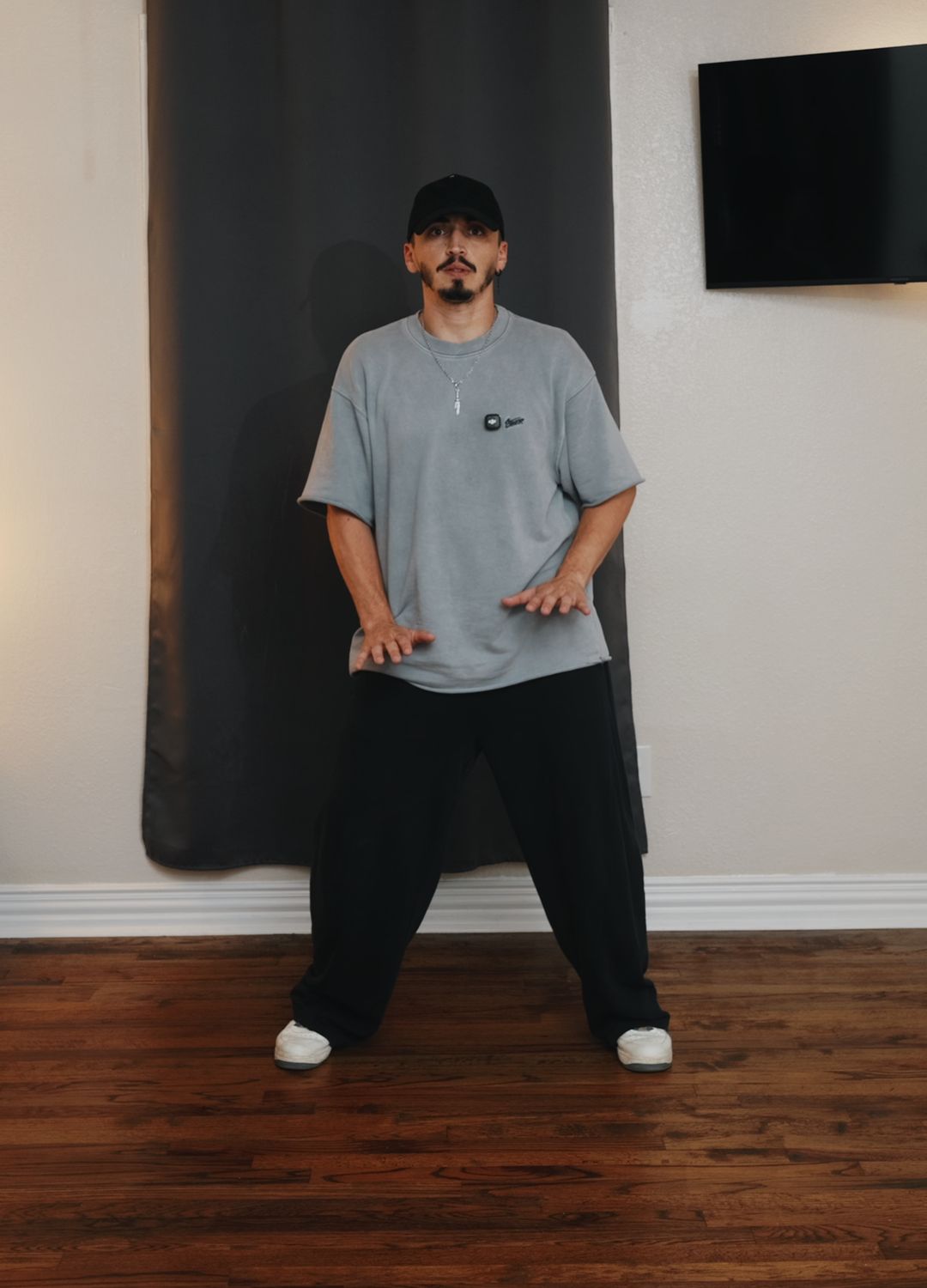 Patrick in a bachata stance in his practice room